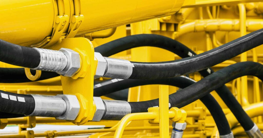 hydraulics pipes and nozzles, tractor or other construction equipment. focus on the hydraulic pipes