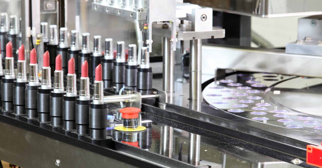 A lipstick packaging machine in a cosmetics factory.