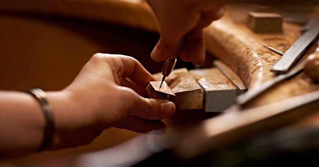 A person using a tool to work on a piece of wood